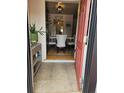 Inviting entryway featuring neutral tile flooring and a peek into the dining area with a modern table setting at 1233 Lansing St, Aurora, CO 80010