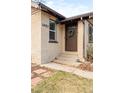 Inviting front entrance featuring a wreath on the door and updated exterior finishes at 1453 Rosemary St, Denver, CO 80220