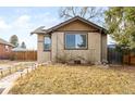 Charming brick home featuring a well-manicured lawn and inviting curb appeal at 1453 Rosemary St, Denver, CO 80220