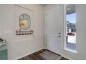 Bright entryway with a stylish mirror, coat rack, and a view of the neighborhood at 17718 Leisure Lake Dr, Monument, CO 80132