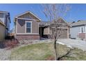 Inviting home exterior with tidy landscaping, a two-car garage, and appealing curb appeal at 17718 Leisure Lake Dr, Monument, CO 80132