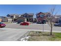 Residential street showcasing well-kept homes, parked cars, and a pleasant neighborhood atmosphere at 17718 Leisure Lake Dr, Monument, CO 80132