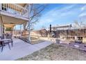 Large backyard with a concrete patio area, perfect for outdoor dining and entertaining guests at 5011 Troy St, Denver, CO 80239