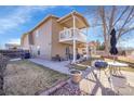 Expansive backyard features a well-maintained lawn, patio, and an outdoor grilling area at 5011 Troy St, Denver, CO 80239