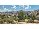 View of homes nestled in a mountainous region with a golf course at 8895 San Antonio St, Littleton, CO 80125