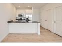Modern kitchen featuring stainless steel appliances, gray countertops, and a convenient breakfast bar for dining at 8895 San Antonio St, Littleton, CO 80125