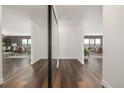 Bright hallway leads to a stylish living area, featuring sleek hardwood floors and a mirrored closet at 460 S Marion Pkwy # 1106, Denver, CO 80209
