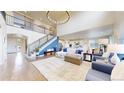 Spacious living room features a staircase, modern lighting, and an open layout for easy entertaining at 5932 Eldora St, Golden, CO 80403