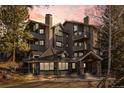 Luxury condo building featuring multiple balconies, stone accents and mountain views at 31819 Rocky Village Dr # 301, Evergreen, CO 80439