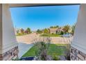 A picturesque neighborhood view from the front porch showcasing lush lawns and various homes at 15122 Fillmore Way, Thornton, CO 80602