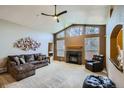 Spacious living room with vaulted ceilings, fireplace, and large windows at 15901 W 66Th Pl, Arvada, CO 80007