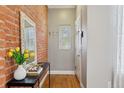 Inviting entryway featuring exposed brick wall and stylish decor at 639 25Th St, Denver, CO 80205