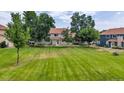 Spacious lawn and mature trees surround the townhome complex at 8406 Everett Way # C, Arvada, CO 80005