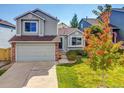 Inviting two-story home with an attached garage, set amidst a lush green lawn and colorful tree at 1462 Hyacinth Way, Superior, CO 80027