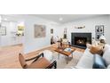 Bright living room with hardwood floors, fireplace, and a cozy seating area with modern decor at 1810 S Kearney St, Denver, CO 80224