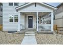 Inviting front porch with steps leading up to the front door and craftsman details at 2751 E 102Nd Pl, Thornton, CO 80229