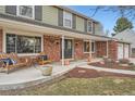 Inviting front porch with brick accents and comfortable seating, perfect for enjoying the outdoors at 7823 S Locust Ct, Centennial, CO 80112