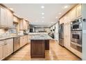 Open kitchen with light wood cabinets, stainless steel appliances, and a granite-topped island at 7823 S Locust Ct, Centennial, CO 80112