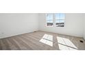 Sunlit bedroom with carpeted floors and a large window overlooking the neighborhood at 3315 N Coolidge Way, Aurora, CO 80019