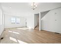 Bright and airy living room with light wood floors, white walls, and natural light at 3315 N Coolidge Way, Aurora, CO 80019