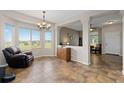 Bright room featuring an adjacent sitting area, large windows, and an open floor plan, perfect for entertaining at 13753 Monroe St, Thornton, CO 80602