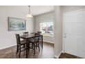 Inviting dining area with natural light, table with seating, and stylish tile flooring at 481 Vista Blvd, Brighton, CO 80603