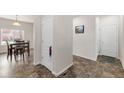 Hallway featuring neutral walls and flooring, with an adjacent dining area at 481 Vista Blvd, Brighton, CO 80603