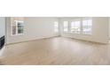 Bright living room with large windows and stylish hardwood floors at 3929 Treadway Pt, Castle Rock, CO 80108