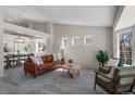 Bright living room featuring stylish furniture, large windows, and an open floor plan at 3966 Aspen Hollow Ct, Castle Rock, CO 80104