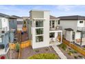 Modern two-story home features fenced yard, balcony, and stylish architectural details at 21440 E 61St Dr, Aurora, CO 80019