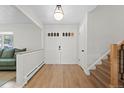 Bright entryway boasts a double-door entry, wood floors and a staircase to the upper level at 10801 W 29Th Ave, Lakewood, CO 80215