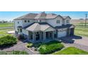Charming two-story home featuring a three-car garage and a cozy front porch at 6051 E 160Th Pl, Brighton, CO 80602