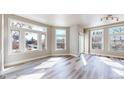 Bright living room featuring large windows, sleek flooring, and neutral wall tones at 2503 N Ogden St, Denver, CO 80205