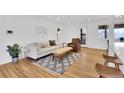 Bright living room with hardwood floors, modern furniture, and a stylish area rug at 2725 S Monroe St, Denver, CO 80210
