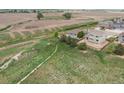 Aerial shot highlighting the home's location near open land, offering a sense of privacy and space at 1523 Honeysuckle Ct, Brighton, CO 80601
