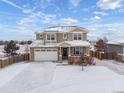 Charming two-story home with stone accents and a covered front porch at 1523 Honeysuckle Ct, Brighton, CO 80601