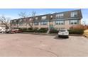Wide exterior shot of building with well maintained landscaping and a parking lot in the front at 9110 E Girard Ave # 1, Denver, CO 80231