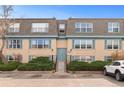 Exterior view of building featuring multiple units, blue shutters, and well maintained landscaping at 9110 E Girard Ave # 1, Denver, CO 80231