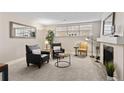 Living room featuring a brick fireplace, large window, neutral paint and carpet at 9110 E Girard Ave # 1, Denver, CO 80231
