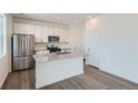 Modern kitchen with stainless steel appliances, granite countertops, and a center island for extra prep space at 13832 Honey Hush Trl, Parker, CO 80134