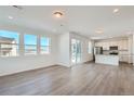 Bright, open-concept living space with hardwood floors, recessed lighting, and large windows with great views at 13832 Honey Hush Trl, Parker, CO 80134