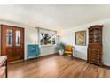 Bright living room with hardwood floors, a large window, and tastefully selected décor at 6719 W 70Th Ave, Arvada, CO 80003