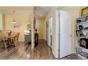 Hallway leading to bathroom and dining area with wood flooring at 15222 E Batavia Pl, Aurora, CO 80011