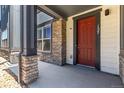 Close-up of a townhome front door, showing the porch and stone details at 157 Ambrose St, Erie, CO 80516