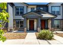 Exterior view of a townhome with a welcoming entrance and stone accents at 157 Ambrose St, Erie, CO 80516