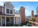 Charming townhome with a brick chimney and well-maintained landscaping at 8265 W 90Th Pl, Broomfield, CO 80021