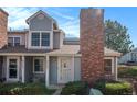 Charming townhome with a brick chimney and well-maintained landscaping at 8265 W 90Th Pl, Broomfield, CO 80021