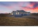 Beautiful modern home with a 2-car garage viewed at sunset at 8648 Carneros Ct, Parker, CO 80138