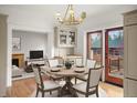 Bright dining room featuring a round table set for four, with a view of the living room and outdoor deck at 841 Niagara St, Denver, CO 80220