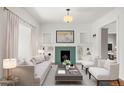 Bright living room featuring a decorative fireplace, built-in shelving, and neutral-toned furniture at 841 Niagara St, Denver, CO 80220
